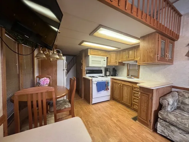 a kitchen with granite countertop a sink stainless steel appliances and cabinets