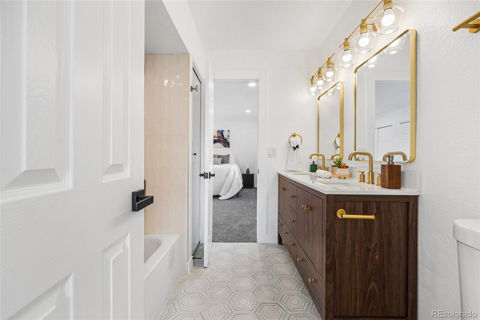 1060 South Parker Road, Unit 35 Denver, CO 80231 - Photo 14 of 25 a spacious bathroom with a double vanity sink a mirror and shower