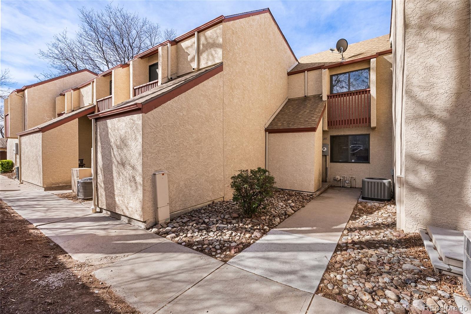 1060 South Parker Road, Unit 35 Denver, CO 80231 - Photo 18 of 25 a front view of a house with a yard