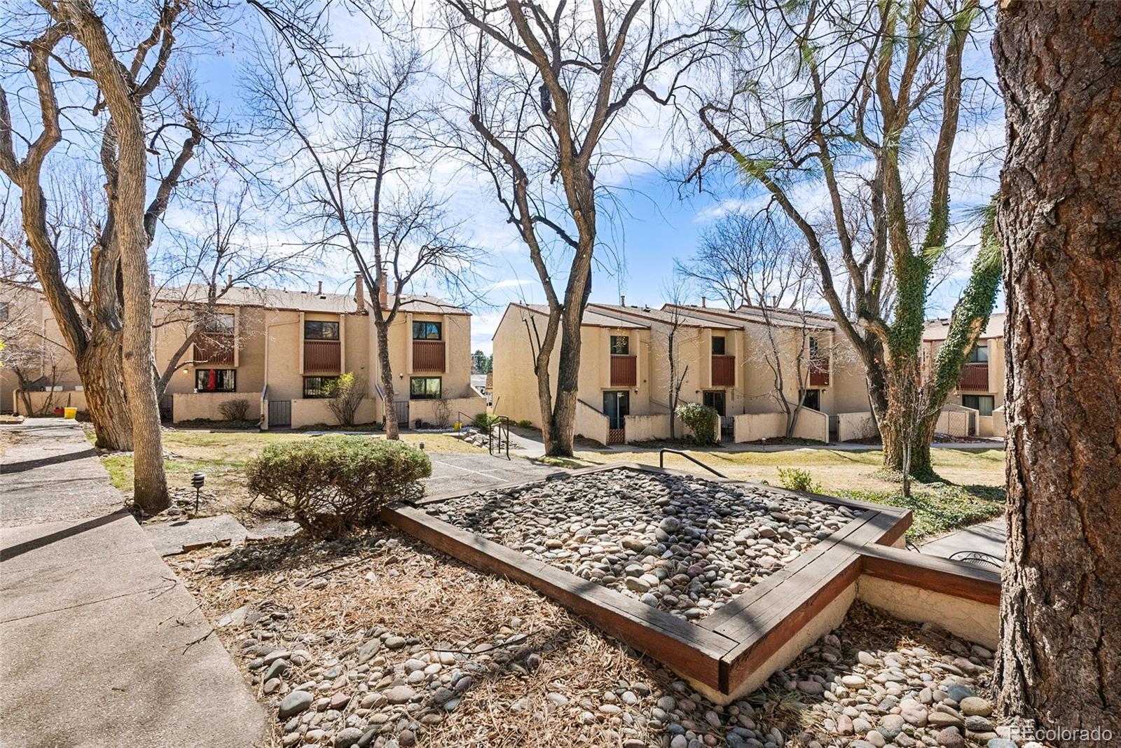 1060 South Parker Road, Unit 35 Denver, CO 80231 - Photo 20 of 25 a view of a house with a yard covered in snow