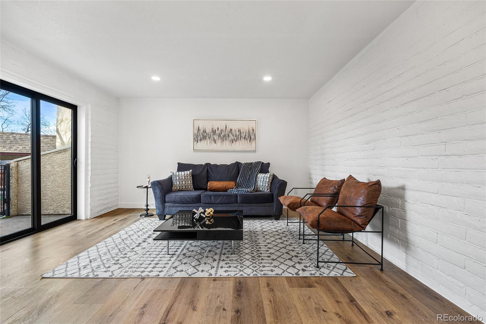 1060 South Parker Road, Unit 35 Denver, CO 80231 - Photo 8 of 25 a living room with furniture and a rug
