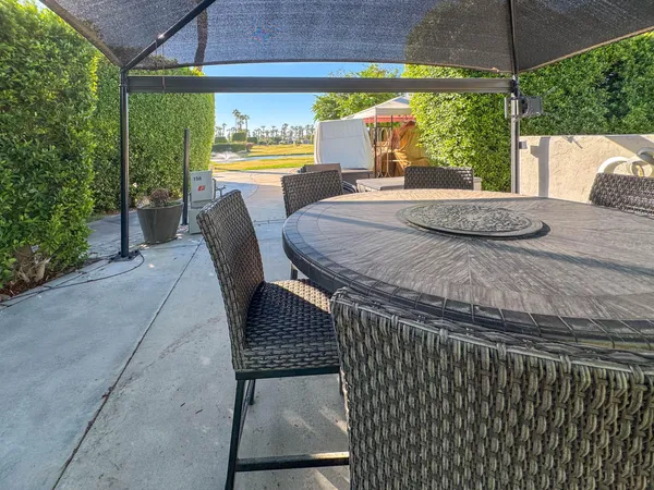 a blue and white umbrella sitting in a backyard