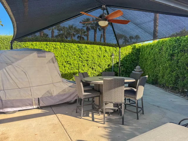 a view of outdoor dining space with a table and chairs