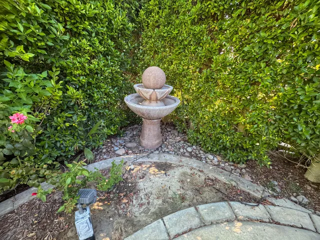 a view of a patio with a table and chairs under an umbrella