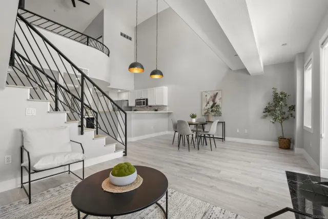 a living room with furniture and a dining table