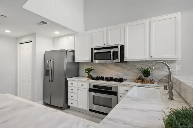 a kitchen with a refrigerator and a sink