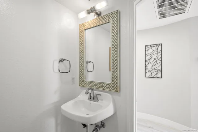a white toilet sitting next to a bathroom sink