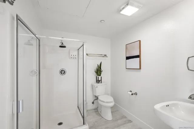 a kitchen with stainless steel appliances granite countertop a refrigerator a stove top oven a sink dishwasher and wooden floor