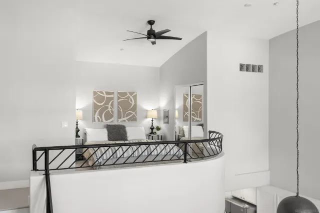 a bedroom with a large bed and a chandelier