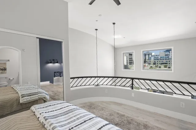 a bedroom with a large bed and a chandelier