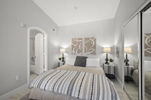 a bathroom with a granite countertop sink toilet and mirror