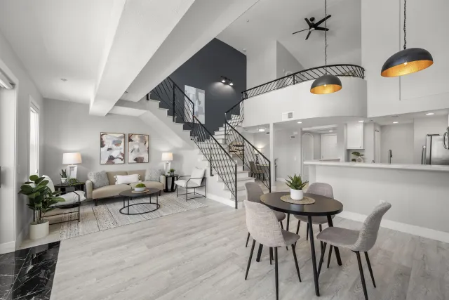 a living room with dining table and wooden floor