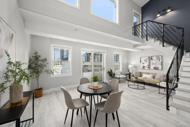 a view of a dining room with furniture window and wooden floor