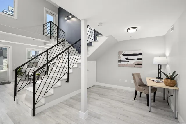 a view of a livingroom with furniture and stairs