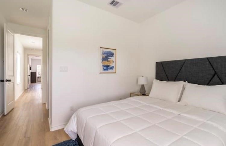 3231 Real Street, Unit B Houston, TX 77087 - Photo 13 of 25 a bedroom with a bed and wooden floor
