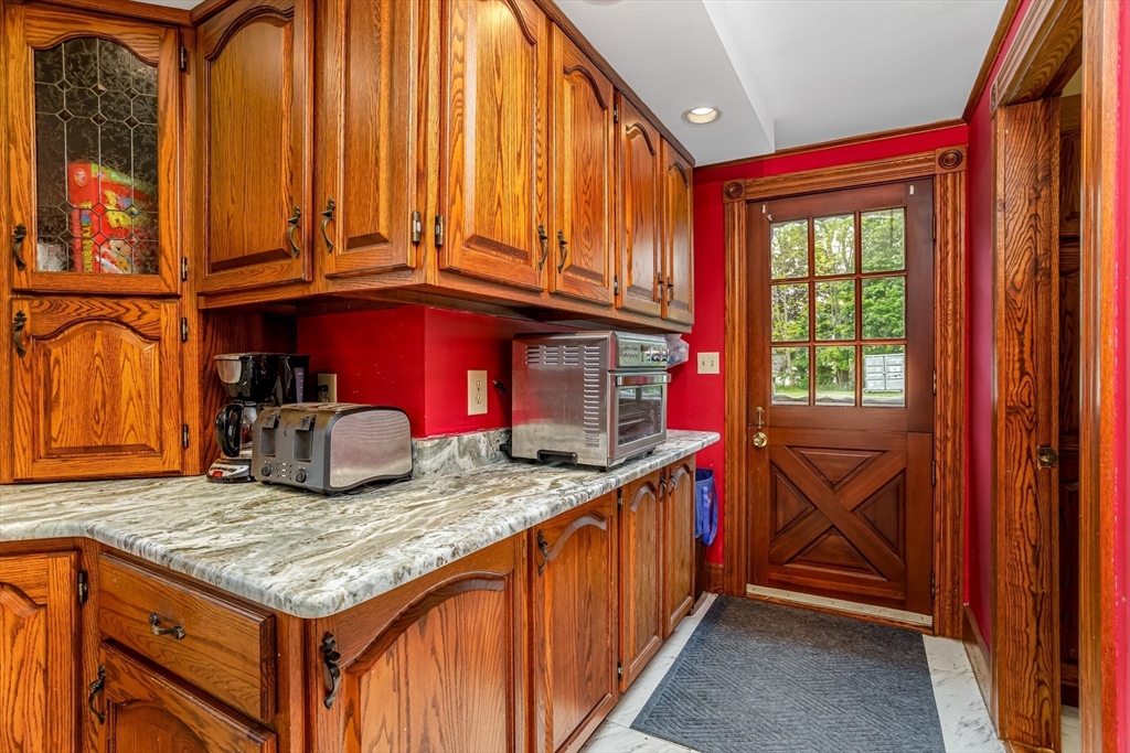 54 Charles Street Gardner, MA 01440 - Photo 6 of 40 a kitchen with kitchen island granite countertop wooden cabinets and entryway