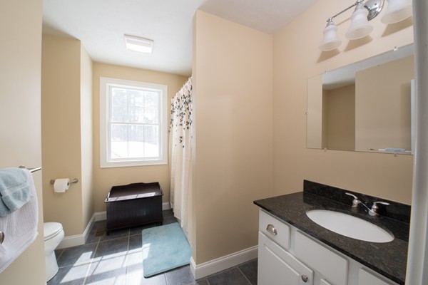 58 Snake Hill Road Ayer, MA 01432 - Photo 16 of 22 a bathroom with a granite countertop sink toilet and mirror