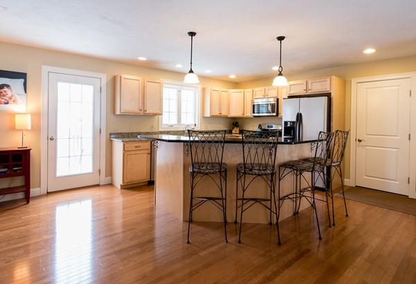 58 Snake Hill Road Ayer, MA 01432 - Photo 4 of 22 a kitchen with stainless steel appliances a dining table chairs sink and wooden floor