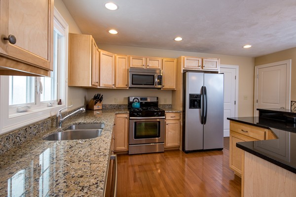 58 Snake Hill Road Ayer, MA 01432 - Photo 6 of 22 a kitchen with granite countertop a refrigerator and a sink