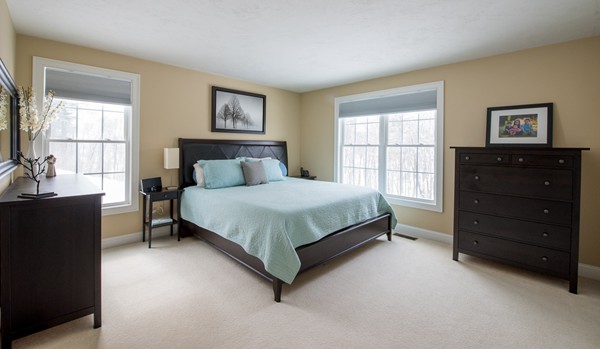 58 Snake Hill Road Ayer, MA 01432 - Photo 9 of 22 a bedroom with a bed and dresser with mirror