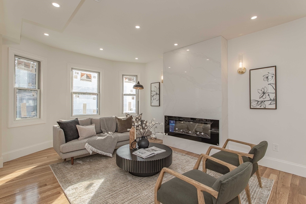 125 Mt Vernon Street, Unit 2 Newton, MA 02465 - Photo 14 of 36 a living room with furniture and a fireplace