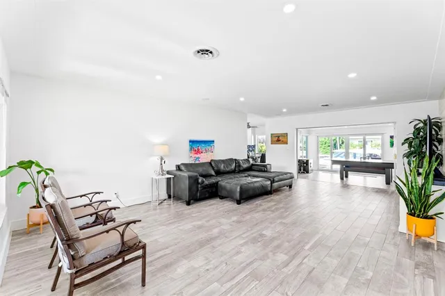 a view of a dining room with furniture wooden floor and windows