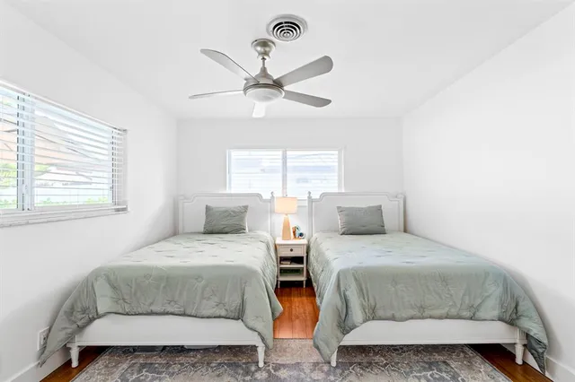 a bathroom with a granite countertop sink a toilet and a shower