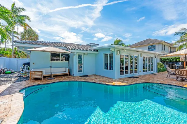 a view of a house with patio and a garden