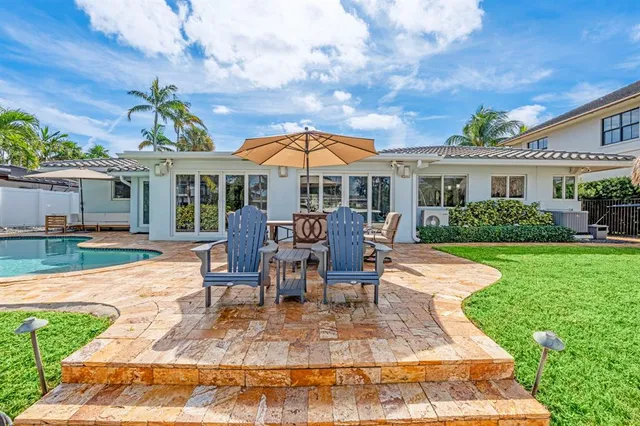swimming pool view with a seating space