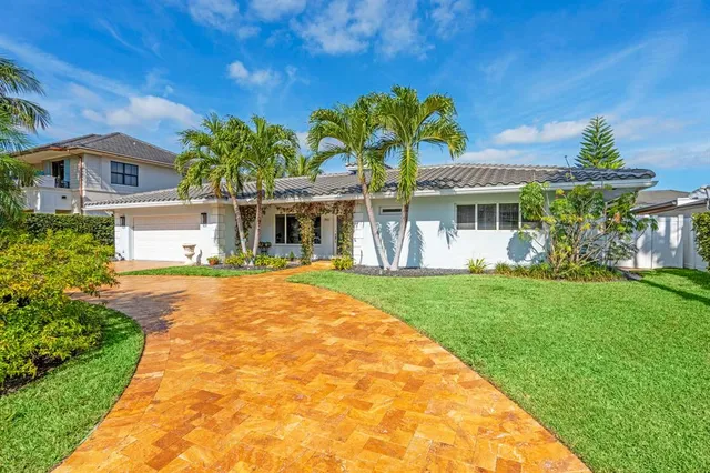 a view of a hallway to a livingroom with furniture