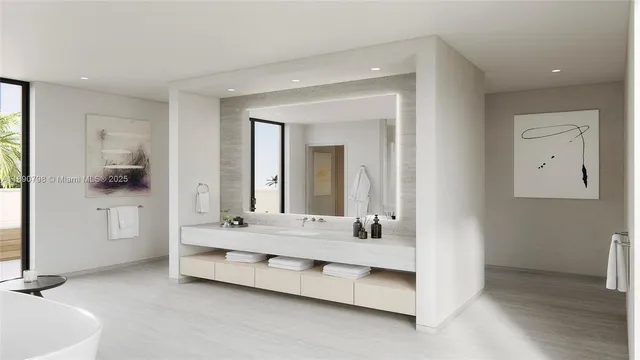 a bathroom with a double vanity sink mirror and tub