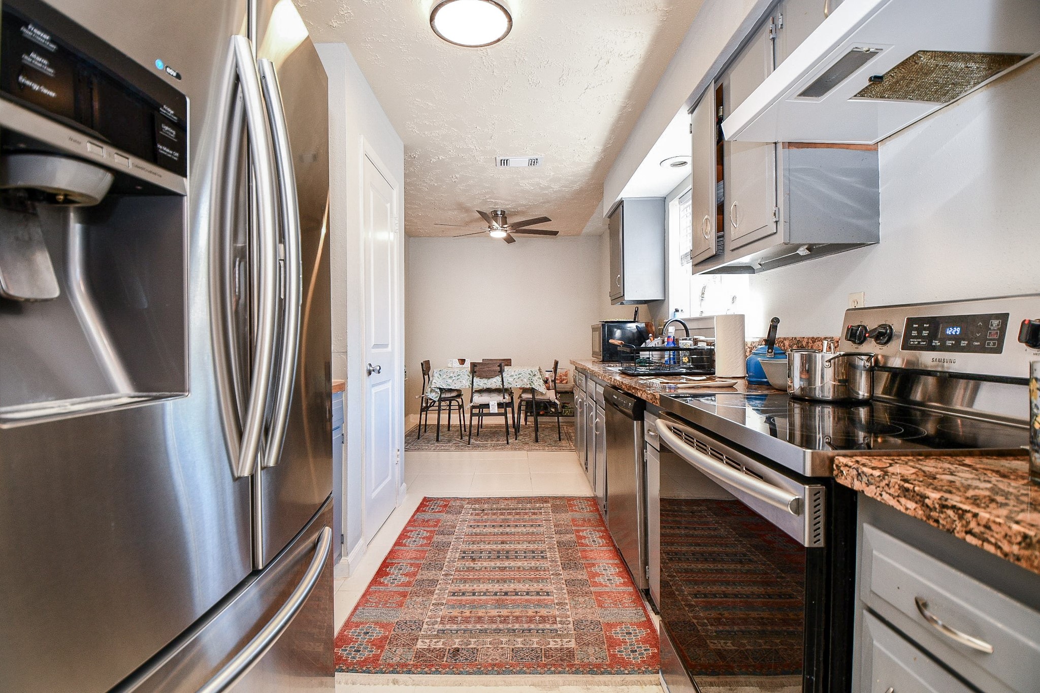 16711 Ribbonridge Drive Sugar Land, TX 77498 - Photo 10 of 24 a kitchen with stainless steel appliances granite countertop a refrigerator and a stove