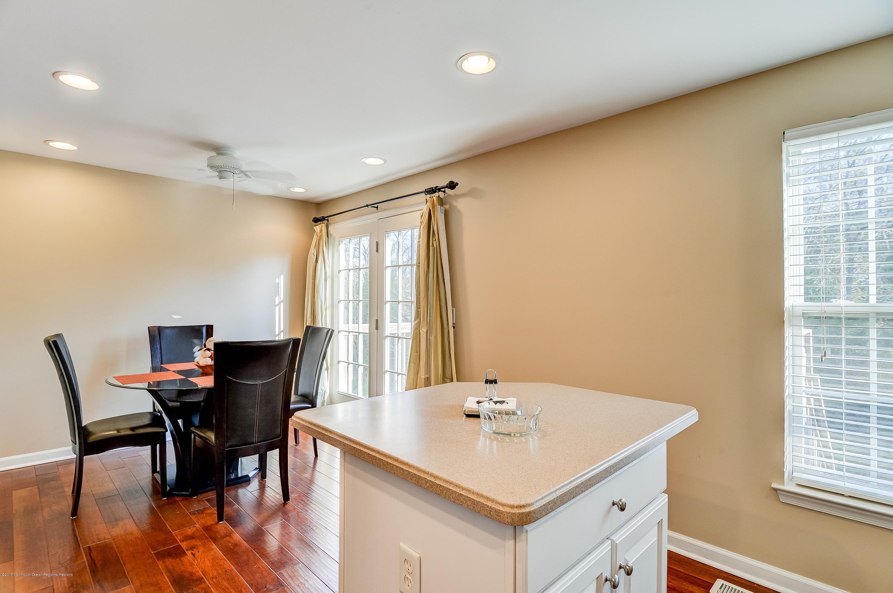 31 Saxton Road, Unit 53 Farmingdale, NJ 07727 - Photo 12 of 25 a view of a dining room with furniture and window
