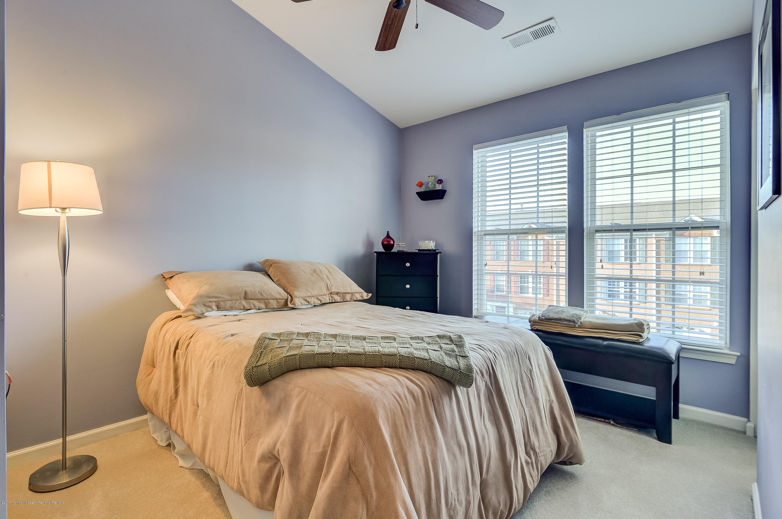 31 Saxton Road, Unit 53 Farmingdale, NJ 07727 - Photo 18 of 25 a bed sitting in a bedroom next to a window