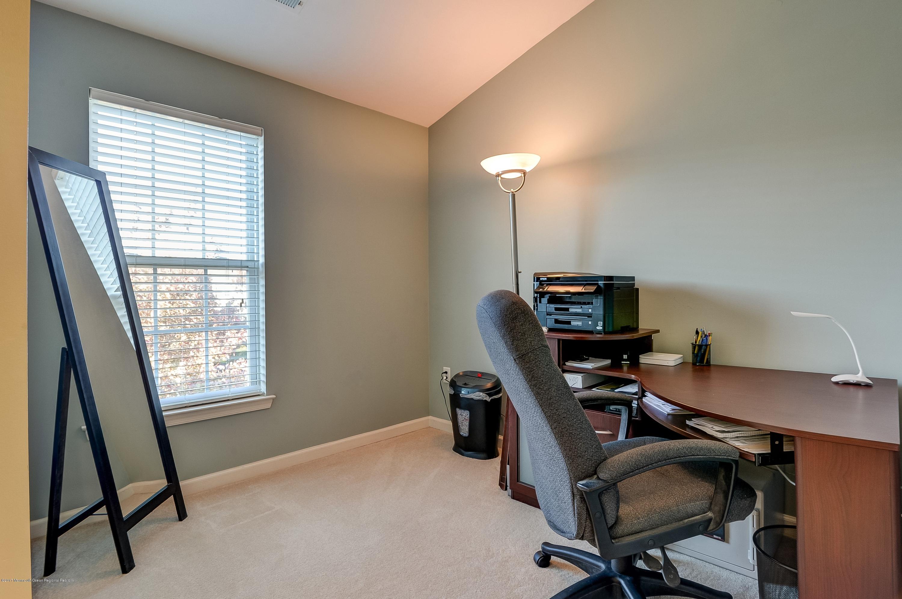 31 Saxton Road, Unit 53 Farmingdale, NJ 07727 - Photo 19 of 25 a view of a workspace with furniture and a window