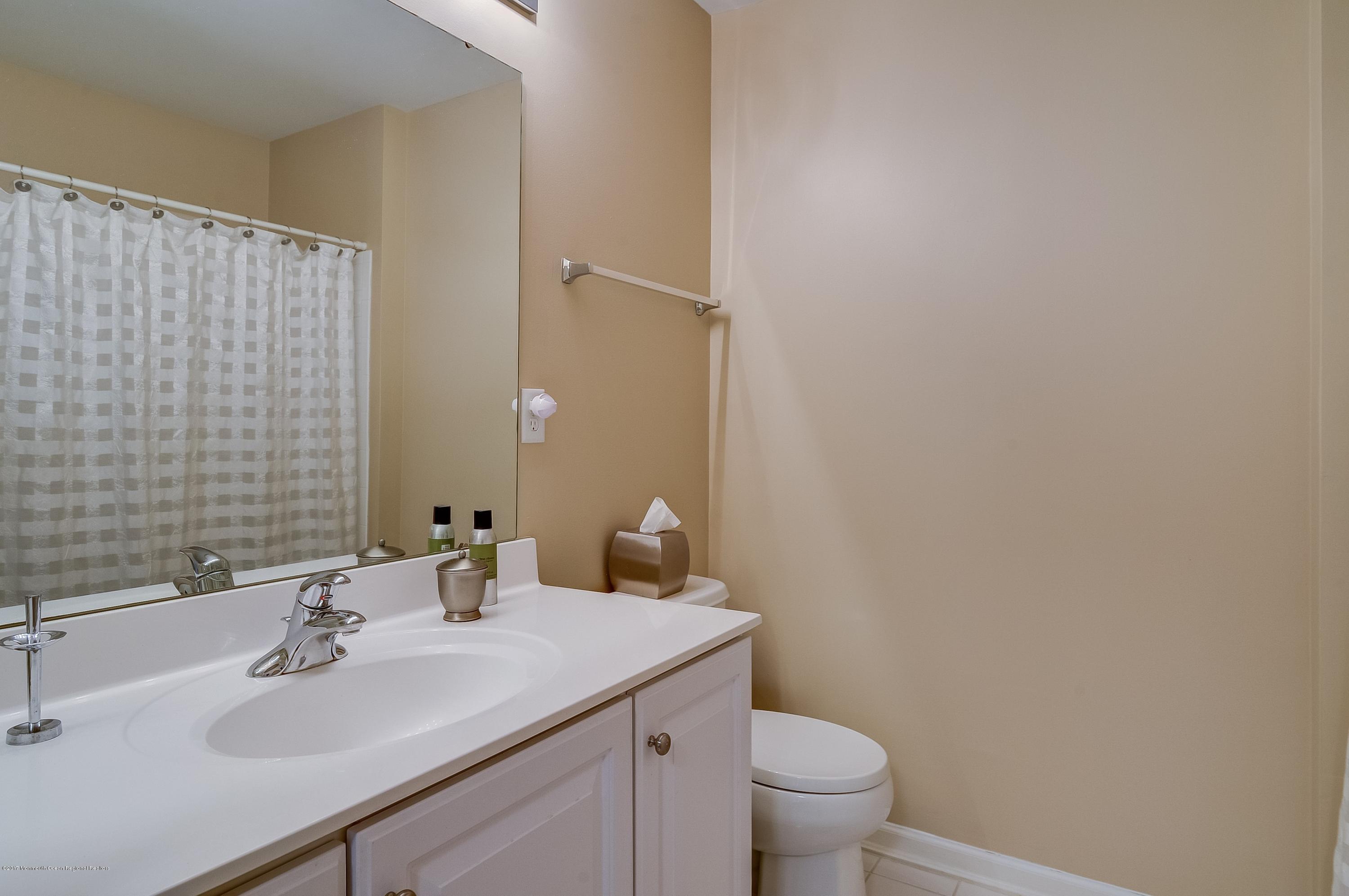 31 Saxton Road, Unit 53 Farmingdale, NJ 07727 - Photo 20 of 25 a bathroom with a sink and a toilet