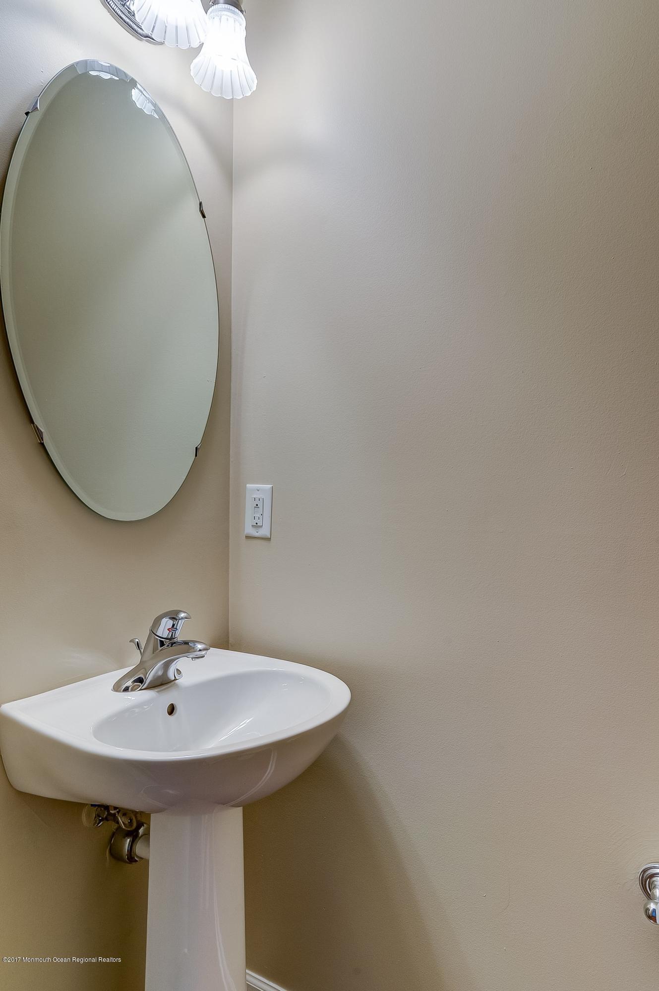 31 Saxton Road, Unit 53 Farmingdale, NJ 07727 - Photo 21 of 25 a sink and a mirror in room