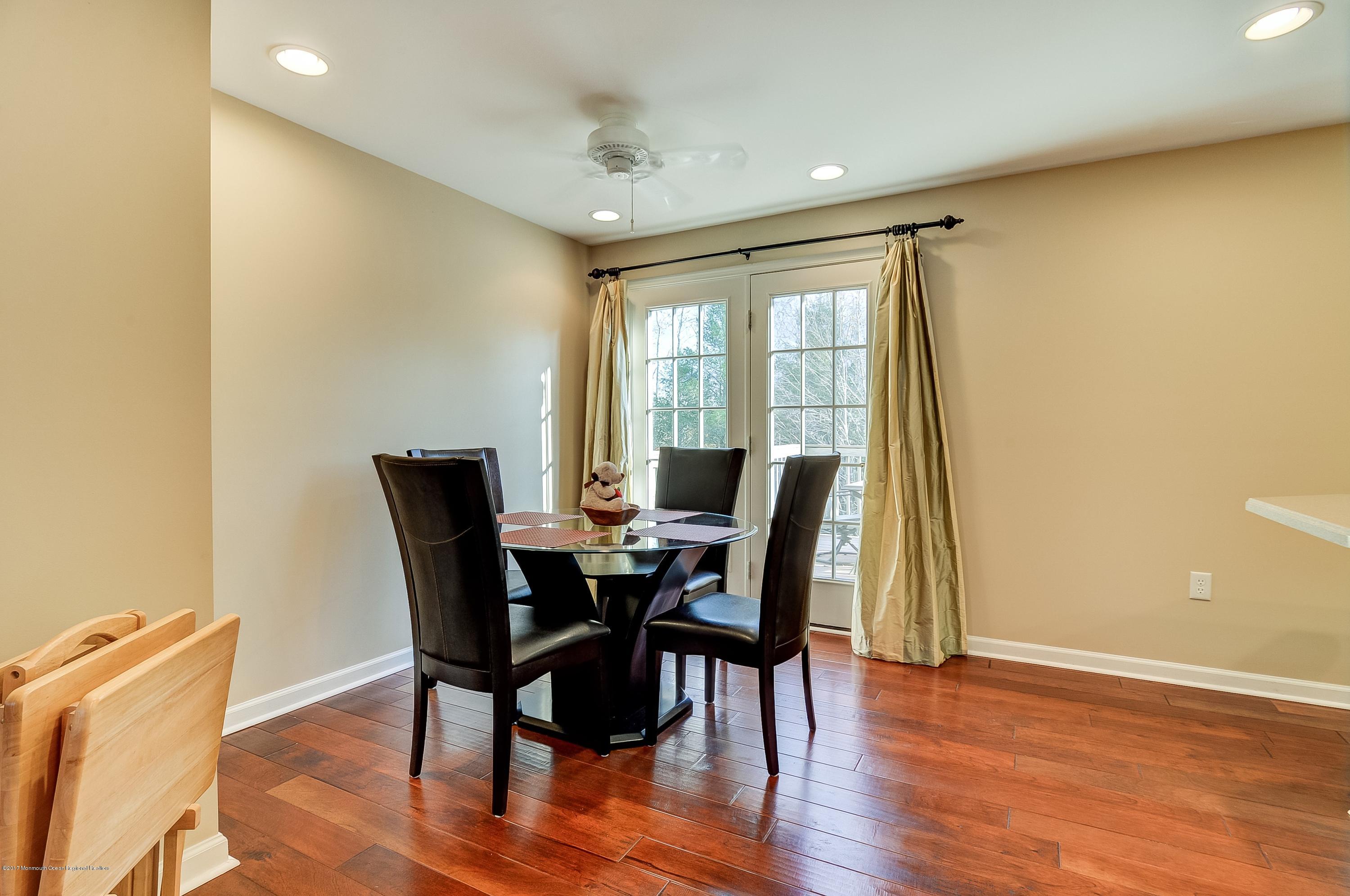 31 Saxton Road, Unit 53 Farmingdale, NJ 07727 - Photo 8 of 25 a view of a dining room with furniture and wooden floor