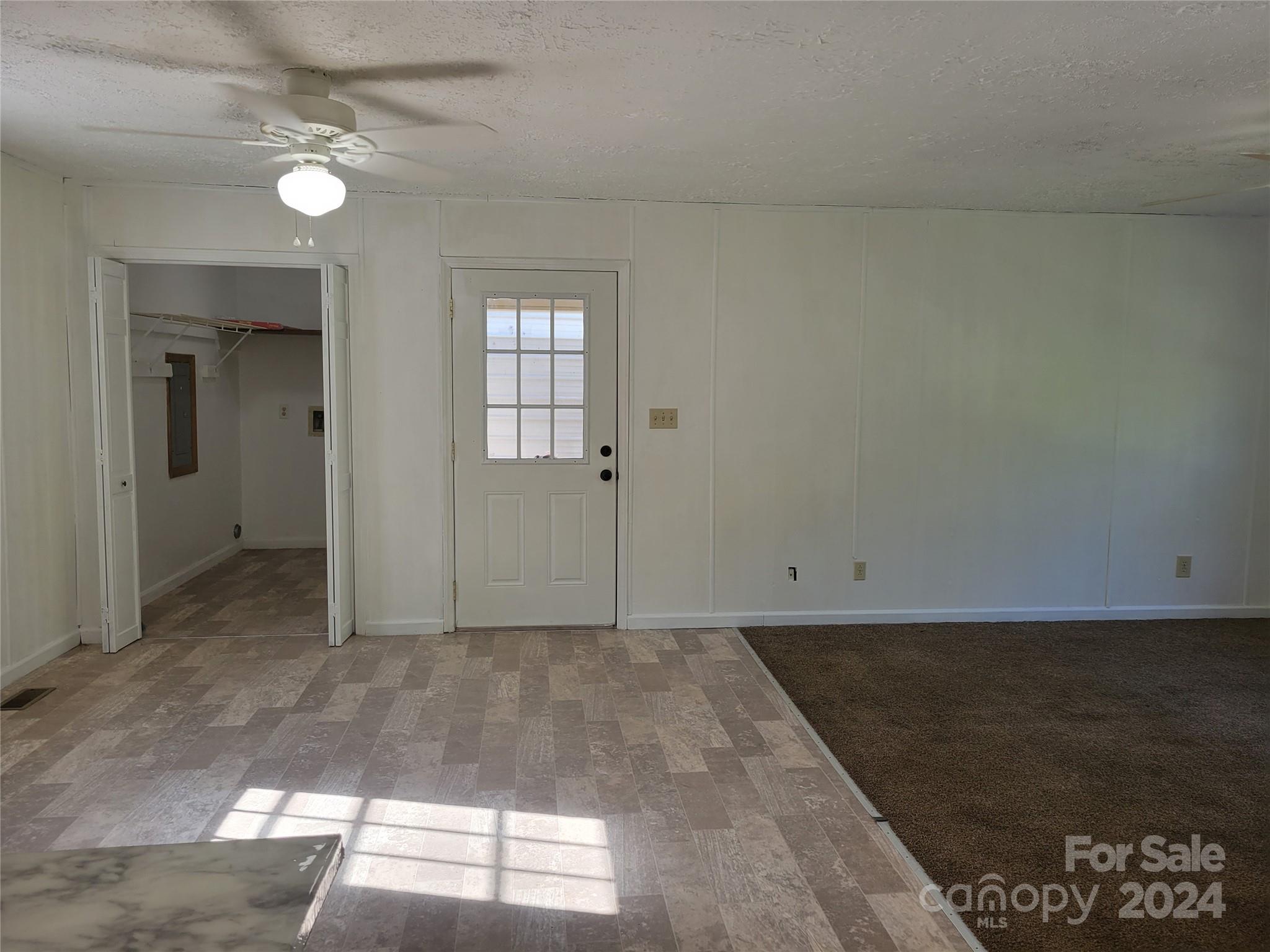 830 Long Branch Road Grover, NC 28073 - Photo 12 of 37 en empty room with windows and ceiling fan