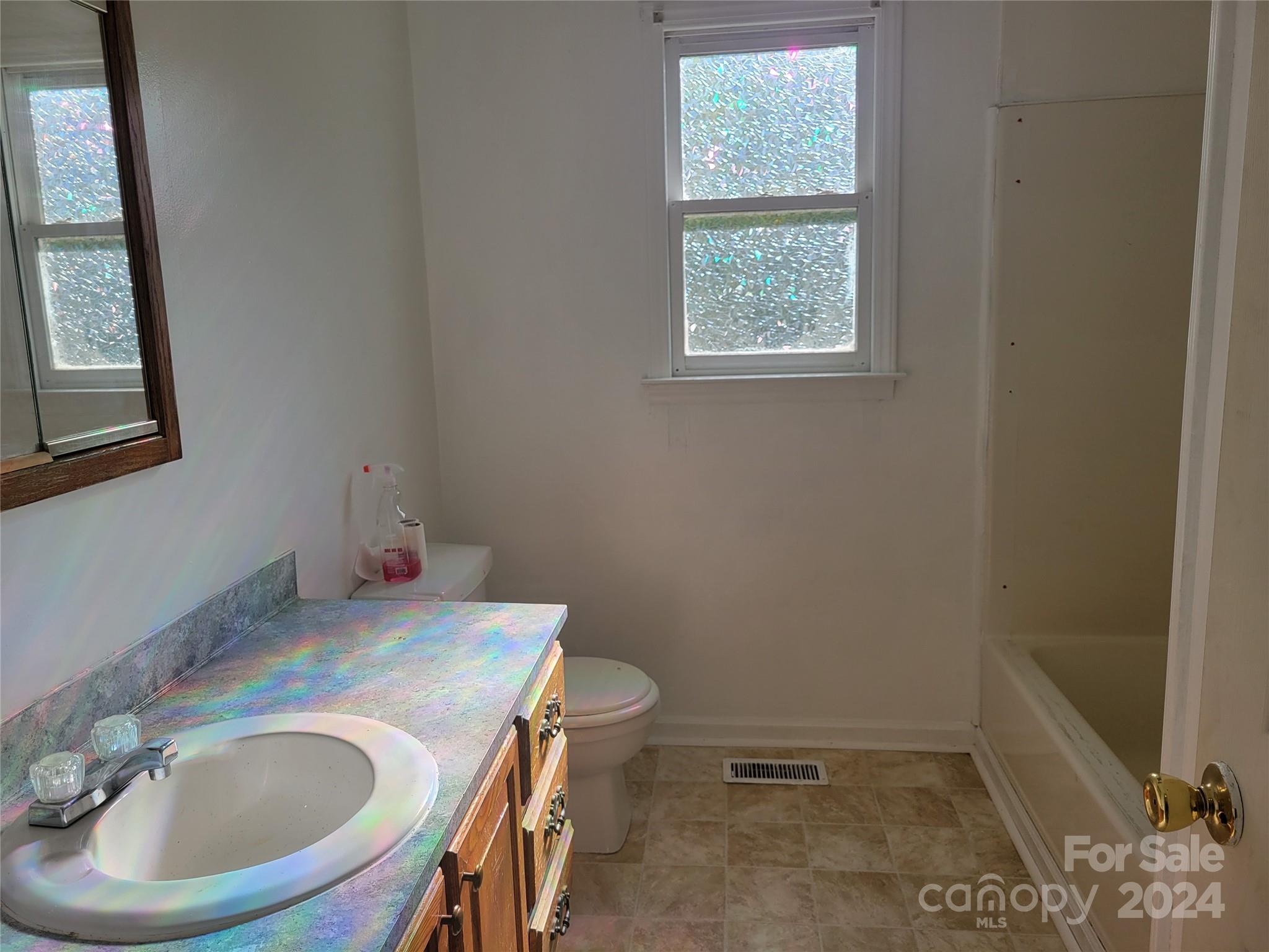 830 Long Branch Road Grover, NC 28073 - Photo 15 of 37 a bathroom with a sink a toilet and a window