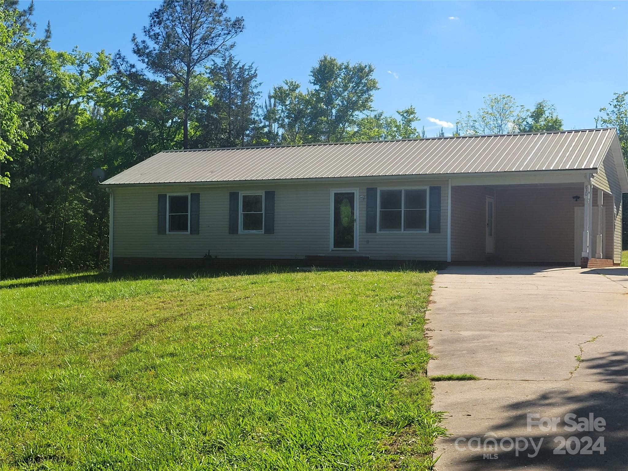 830 Long Branch Road Grover, NC 28073 - Photo 2 of 37 a house with a garden
