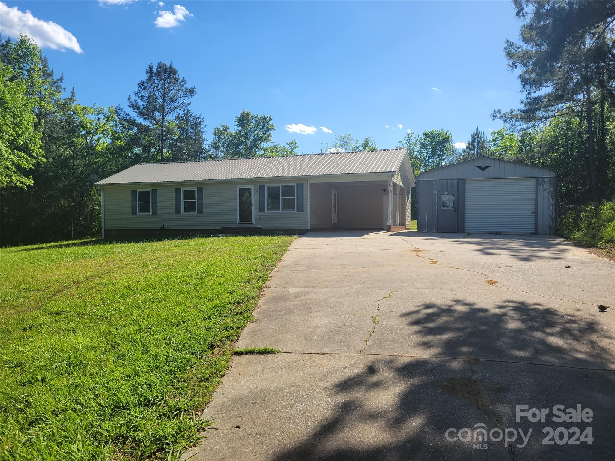 830 Long Branch Road Grover, NC 28073 - Photo 3 of 37 a front view of house with yard and trees in the background