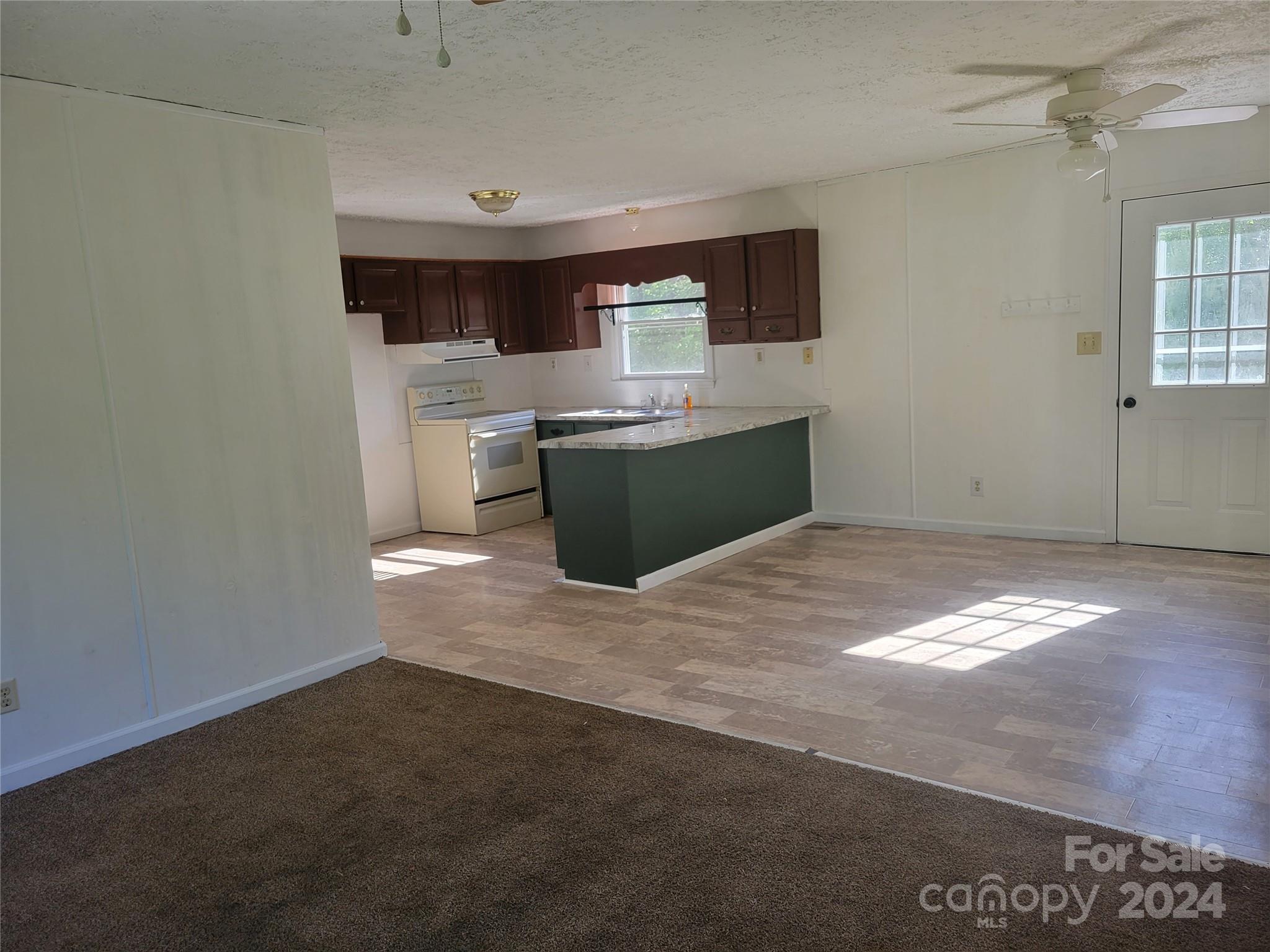 830 Long Branch Road Grover, NC 28073 - Photo 6 of 37 a kitchen with stainless steel appliances granite countertop a stove a sink and a refrigerator