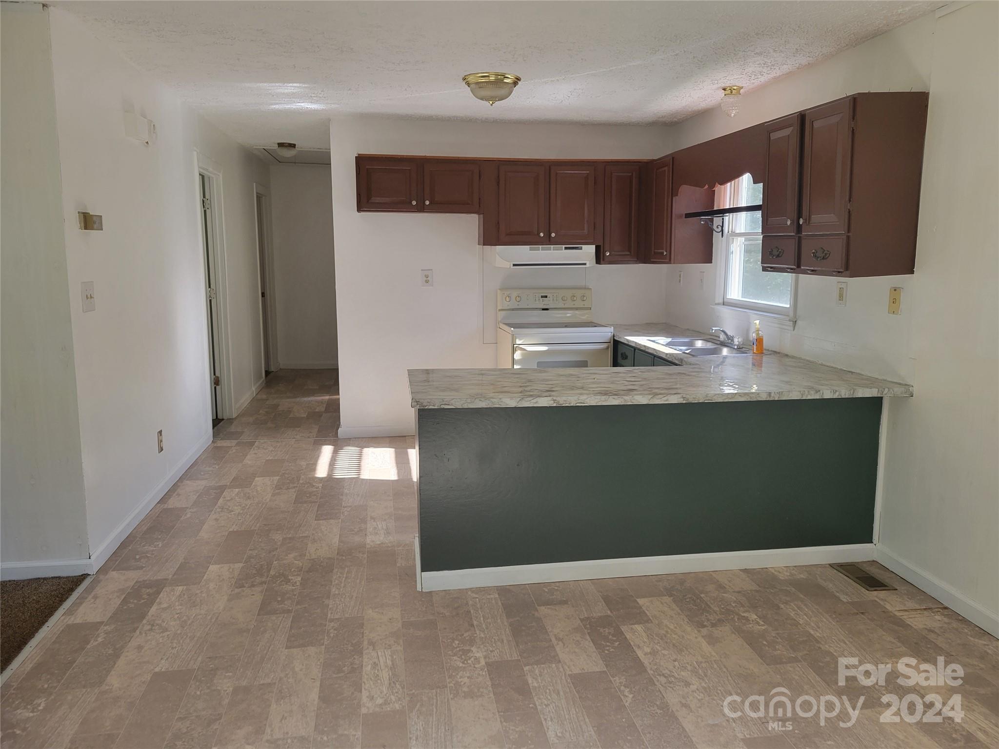 830 Long Branch Road Grover, NC 28073 - Photo 10 of 37 a kitchen with stainless steel appliances granite countertop a stove a sink and a refrigerator