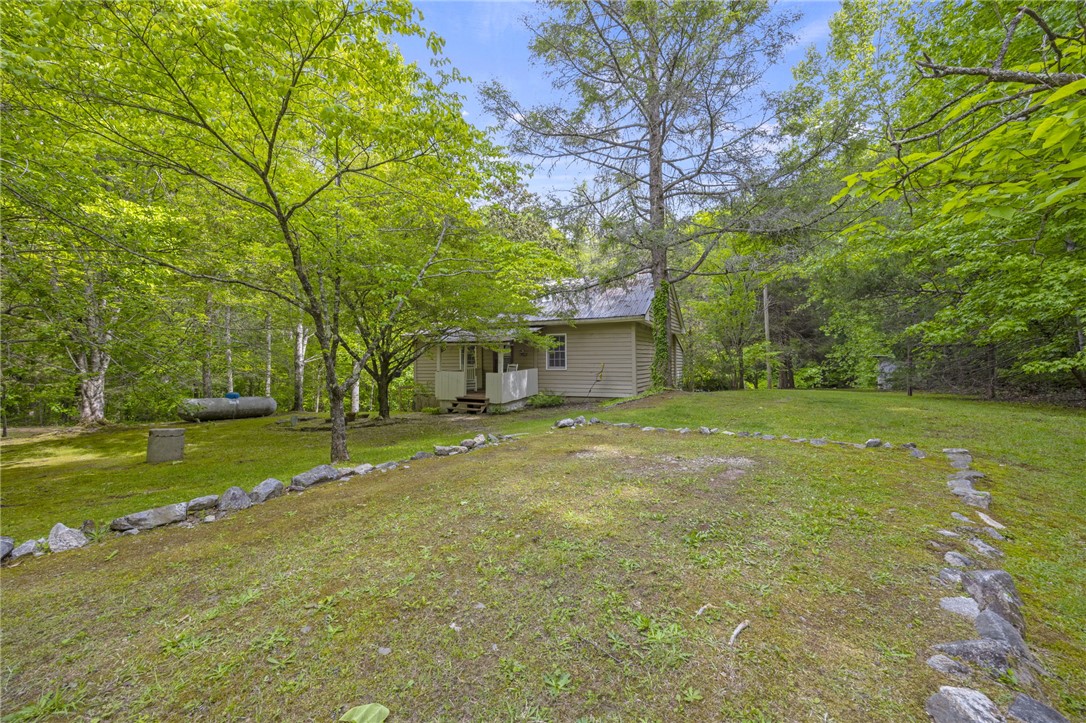 437 West Gate Road Pickens, SC 29671 - Photo 38 of 47 This charming home offers a serene escape, nestled among lush greenery and mature trees.