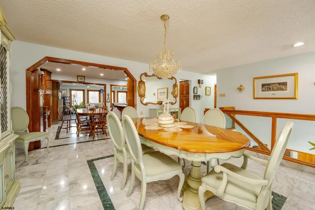 a bedroom with a bed and a table with the outer view