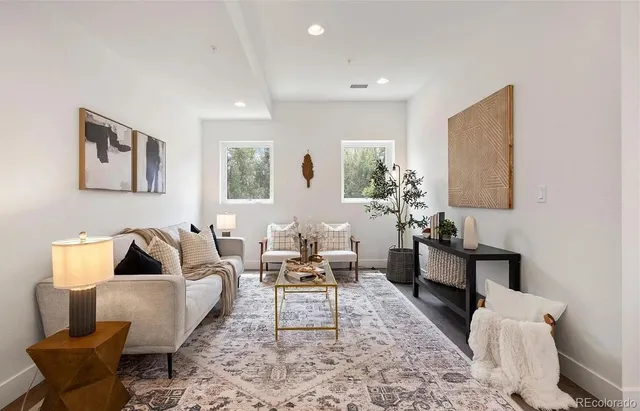 a living room with furniture or couch and a potted plant