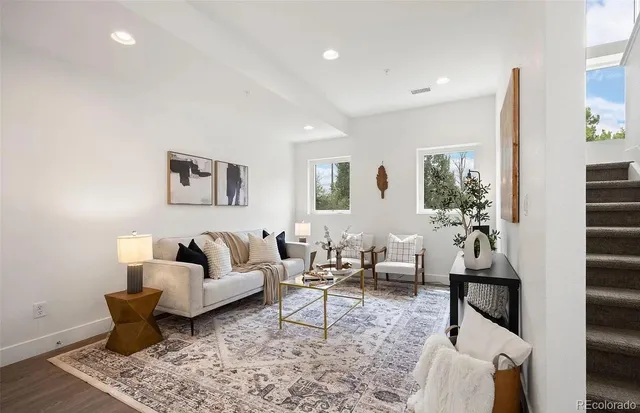 a living room with furniture and wooden floor
