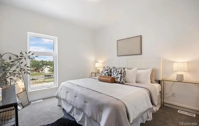 a bedroom with a bed and a window