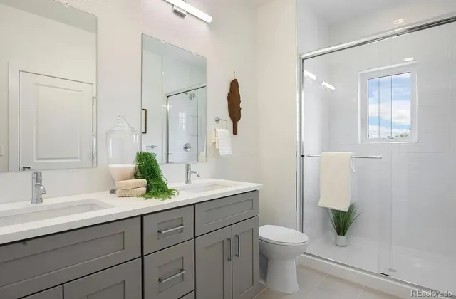 a bathroom with a granite countertop sink a toilet and a mirror
